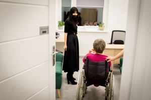kobiet oprowadzająca kobietę na wózku inwalidzkim